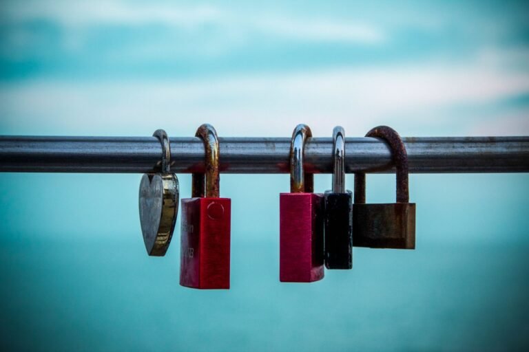 Lovelocks hanging on a rail in Grado, Italy, symbolizing love and commitment with a sea backdrop.