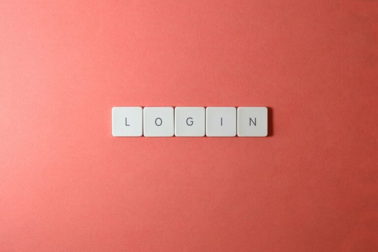 Close-up of login keyboard tiles on a coral background, perfect for tech themes.