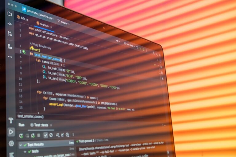 Colorful abstract reflection on screen showing programming code in development environment.